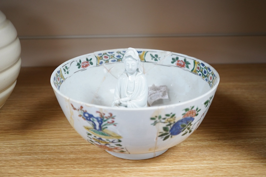 A Chinese famille verte bowl, Kangxi period and a white glazed figure of Guanyin, bowl 22cm diameter. Condition - figure good, bowl poor